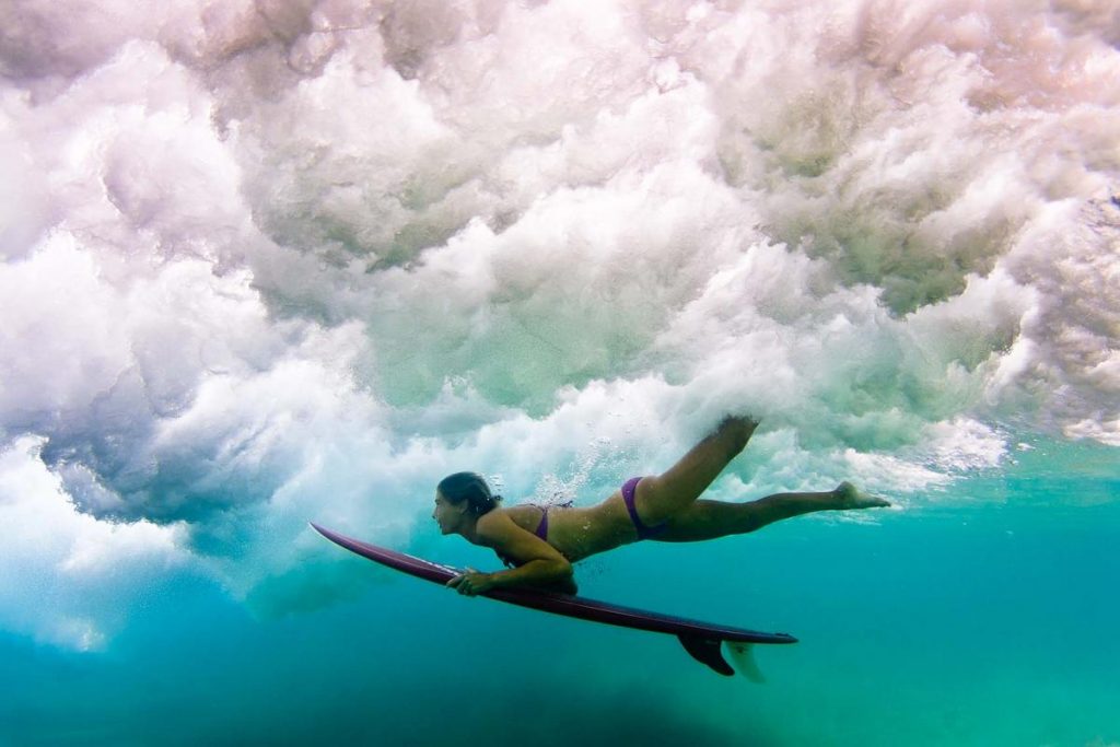 Belinda Baggs ducking underneath a wave in New South Wales, Australia